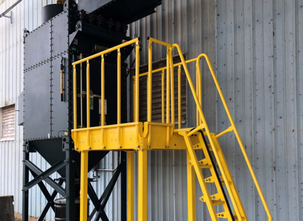 yellow Lapeyre alternating tread stairs provide access to a dust collector